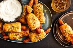 two plates filled with pastries and dipping sauce