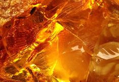 an orange and yellow piece of glass sitting on top of a table