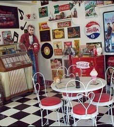 a room filled with furniture and pictures on the wall next to a checkered floor