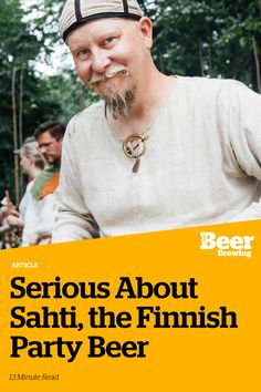 a man with a beard wearing a baseball cap and holding a beer in his hand