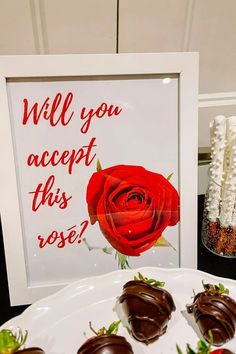 chocolate covered strawberries sit on a plate in front of a sign that says will you accept this rose?