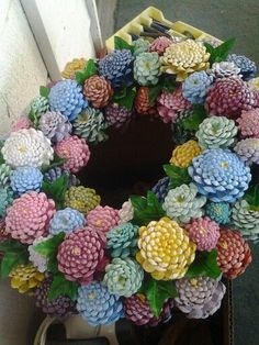 a wreath made out of fake flowers sitting on top of a table