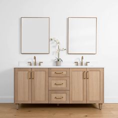 two mirrors are above the double sink vanity in this white and beige bathroom with wood flooring