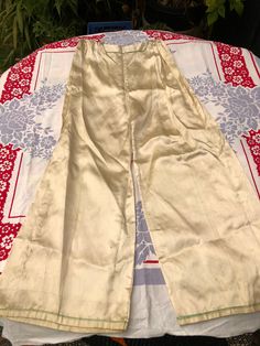 "Gorgeously aged 1920's cream satin pajama set. Probably Chinese or after the style of pongee sets from China. Gold thread embroidered dragon. Snap closures. Two small front pockets. Wide leg pants with flat front and elastic gathered hip and back. Cords for adjusting fit. Top has full sleeves, gathered at cuffs. An elegant, Art Deco vibe. Lots of age, water staining, small repairs, slight fraying of weave. The crotch of the pants has a hole that can be repaired. Pants come with original safety 1920s Pajamas, Embroidered Dragon, Satin Pajama Set, Satin Pajama, Pajama Suit, Satin Pyjama Set, Elegant Art, Satin Pajamas, Womens Pyjama Sets