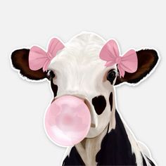 a close up of a cow with a pink bubble in its mouth