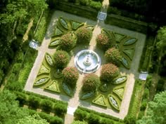 an aerial view of a garden in the middle of trees