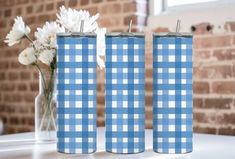 three blue and white vases sitting on top of a table