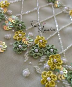 the beaded necklace is decorated with flowers and pearls