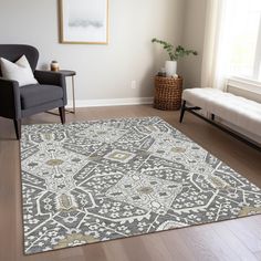 a living room with a large rug on the floor and a chair next to it