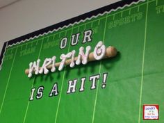 a green wall with writing on it and a baseball bat