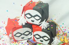 three boxes with masks on them surrounded by confetti and sprinkles