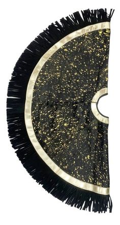 a black and gold fan shaped object with fringes on the sides, against a white background