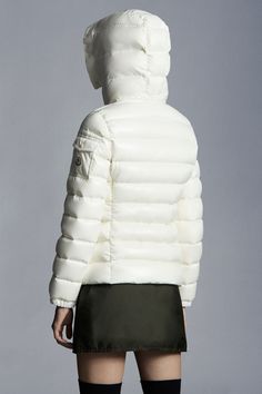 In line with the collection's clean, graphic aesthetic, the Badyf is a slim fit down jacket crafted from nylon laqué. In a play on textures, the glossy puffer is embellished with a faux fur trim along the hood - easily detached depending on the temperature and your mood. White Nylon Outerwear With Zipper Closure, White Quilted Fitted Outerwear, Luxury White Puffer Jacket With Padded Collar, Fitted Quilted White Outerwear, Luxury White Puffer Jacket For Winter, Luxury White Outerwear For Streetwear, White Fitted Quilted Outerwear, Luxury White Winter Puffer Jacket, Luxury White Streetwear Outerwear