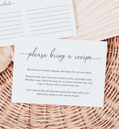 two pieces of paper sitting on top of a wicker basket next to each other