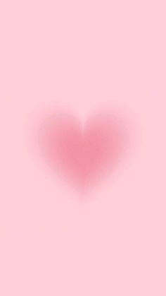 a pink heart shaped object is shown in the middle of a light pink wallpaper