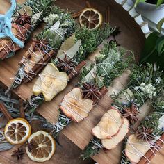 an assortment of dried fruit and herbs on a cutting board