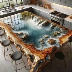 a kitchen table with an artistic design on the top and water running down it's side