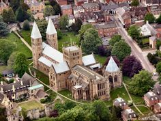 an aerial view of a large church in the middle of a small town with lots of trees