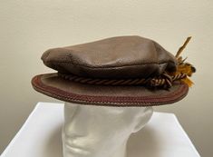 "A new professional quality Renaissance Medieval Tudor brim muffin poet floppy hat. This brown deluxe leather look brim hat is embellished with a matching braided band and pheasant feather cluster. Inside lining. New not worn. A great accent for your Medieval Renaissance outfit for your reenactment event, theme party or stage production. All sales final. Will exchange for a different size. Size large has a 23\" band" Medieval Poet Outfit, Adjustable Brown Top Hat For Costume, Brown Adjustable Top Hat For Costume, Vintage Brimmed Costume Accessories, Brown Adjustable Costume Hats And Headpieces, Stage Production, Pheasant Feather, Pheasant Feathers, Leather Hats