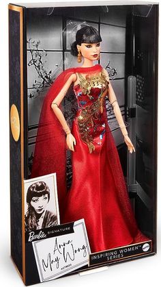 a barbie doll in a red dress with gold accents and a black hairdow