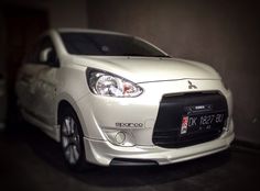 a small white car parked in a garage