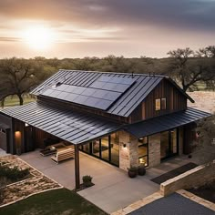 an aerial view of a house with solar panels on it's roof and patio