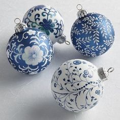 four blue and white ornaments sitting on top of a table