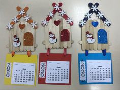 three popsicle calendars with snowmen and houses on them, one for each year