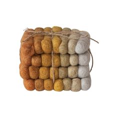 several different colored balls of wool tied together in twine on a white background with space for text