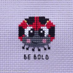 a cross stitch picture with the words be bold written in black, white and red