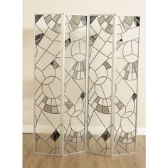 a room divider made out of stained glass with geometric designs on the side and sides