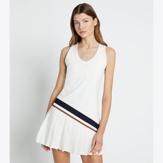 Featuring our signature chevron graphic, the fitted tennis dress is designed with a racerback top, built-in padded bra and pleated skirt. Crafted in lightweight performance jersey, it is breathable and moisture wicking — perfect to optimize performance during hot days on the court. Sleeveless Summer Tennis Dress, Sleeveless Tennis Dress For Summer, Sleeveless Tennis Mini Dress For Spring, Sleeveless Mini Tennis Dress For Spring, Summer Tennis Dresses In Athleisure Style, Sporty Racerback Summer Dresses, White Racerback Dress For Summer, Summer Tennis Dress In Athleisure Style, Sporty Tennis Mini Dress For Spring