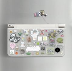 a refrigerator with magnets and stickers on it