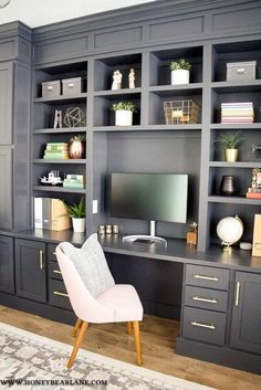 a living room filled with furniture and a flat screen tv sitting on top of a wooden desk