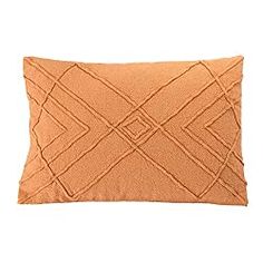 an orange pillow on a white background with a diamond pattern in the middle and a square shape