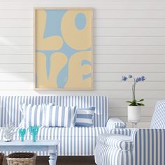 a blue and white striped couch sitting in a living room next to a coffee table