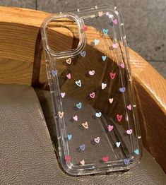 the back of a phone case with hearts on it sitting on top of a car seat