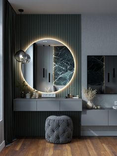 a bathroom with a round mirror on the wall next to a vanity and stool in front of it