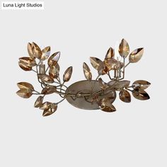 an image of a light fixture with leaves on the top and bottom part of it