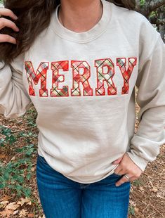 "MERRY APPLIQUE EMBROIDERED APPAREL ♡ Heavy Blend Crewneck Sweatshirt - Unisex ♡ Merry Applique Crewneck ♡ 50/50 Cotton/Polyester ♡ Made in the U.S. ♡ Model is wearing \"Sand\"; Size: \"S\" IMPORTANT NOTICE: Crewnecks now have a paper like stabilizer that appears on the inside. This helps with increasing quality and ensure a longer lasting design on the sweatshirts. NOTE: INVENTORY IS CONSTANTLY CHANGING. We may need to alter your order if something becomes sold out. Sorry for this inconvenience, but we are working on resolving this issue. Please message Kewteepie if a larger size is needed and we will check on sizes available for accommodation. ----------------------------------------------------------------------- CREWNECKS RUN ON THE SMALLER END, WE RECOMMEND SIZING UP FOR A LOSER FIT!! Embroidered Apparel, Applique Sweatshirt, Diy Sweatshirt, Reverse Applique, Christmas Crewneck, Embroidered Crewneck, Holiday Sweatshirt, Shirt Embroidery, Embroidered Clothes