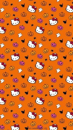 an orange background with hello kitty faces and pumpkins