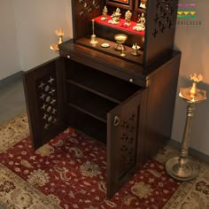 a wooden desk with many items on it and a rug in front of the table