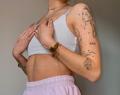 a woman with tattoos on her arm and chest