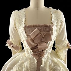 A Rococo Style gown made from polyester dupioni. The gown features an abundance of ruffles, made from the same fabric as the gown and strategically placed to add volume and movement to the dress. The separate underskirt is also decorated with ruffles and will provide additional volume and texture to the overall look of the gown. The sack back drapes elegantly over the back and hips and creates a soft, flowing silhouette.This dress can be made in many different color combinations. The front of the dress has a stomacher panel that is attached to one side and hooks closed on the other. Ties on the inside back of the dress allow the fit to be adjusted for the perfect look! When purchasing, please include your bust, waist, and hip measurements in the purchase notes, or as a separate message to