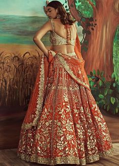 Features an orange lehenga in luxurious organza embellished with leather applique and highlighted with mirrorwork and rose gold sequins work. Teamed with a contrasting gold blouse and a matching orange and gold net dupatta embroidered with buttis and a gold border. Composition: Lehenga- Organza, Blouse-Organza, Dupatta-Net Care: Dry Clean Only and Vacuum Storage This product can be customised for sleeves, length of blouse and neckline Delivery : 6-8 weeks as the product is hand crafted. For more Orange Indian Dress, Sequins Lehenga, Lehenga And Blouse, Orange Lehenga, Leather Applique, Walima Dress, Bridal Lehenga Designs, Organza Lehenga, Yellow Lehenga