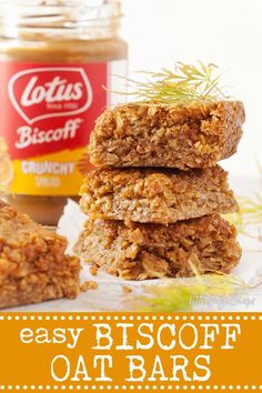 three oat bars stacked on top of each other next to a jar of peanut butter