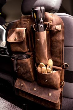 the back seat of a car filled with leather items