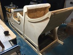 an unfinished boat is being worked on in a shop