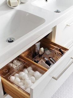 an open drawer in a bathroom next to a sink