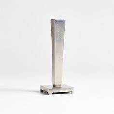 a tall metal object sitting on top of a white surface with no one around it